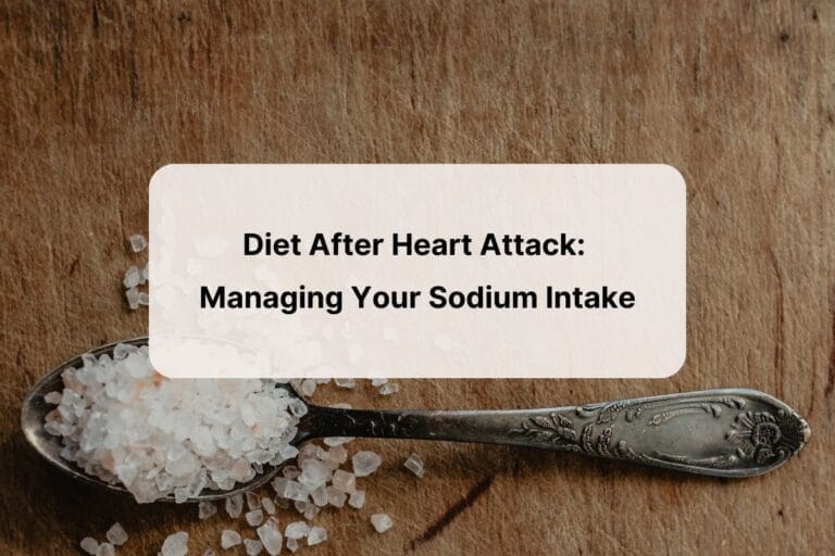 Photo of a silver spoon holding sea salt granules on a wooden background, with overlay of blog article title--"diet after heart attack: managing your sodium intake".